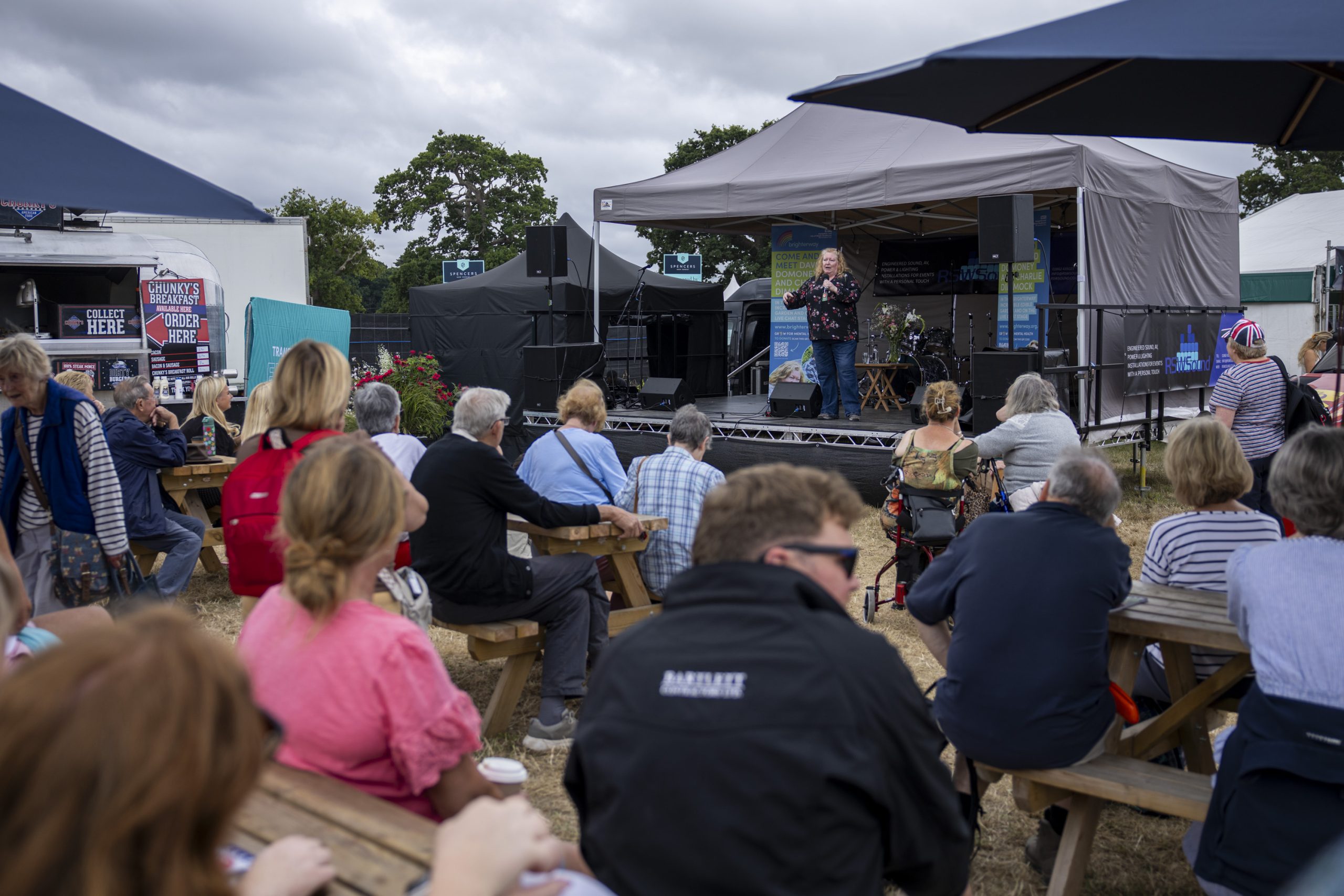 People sit listening to a talk by TV gardening celebrity Charlie Dimmock at the New Forest Show 2025