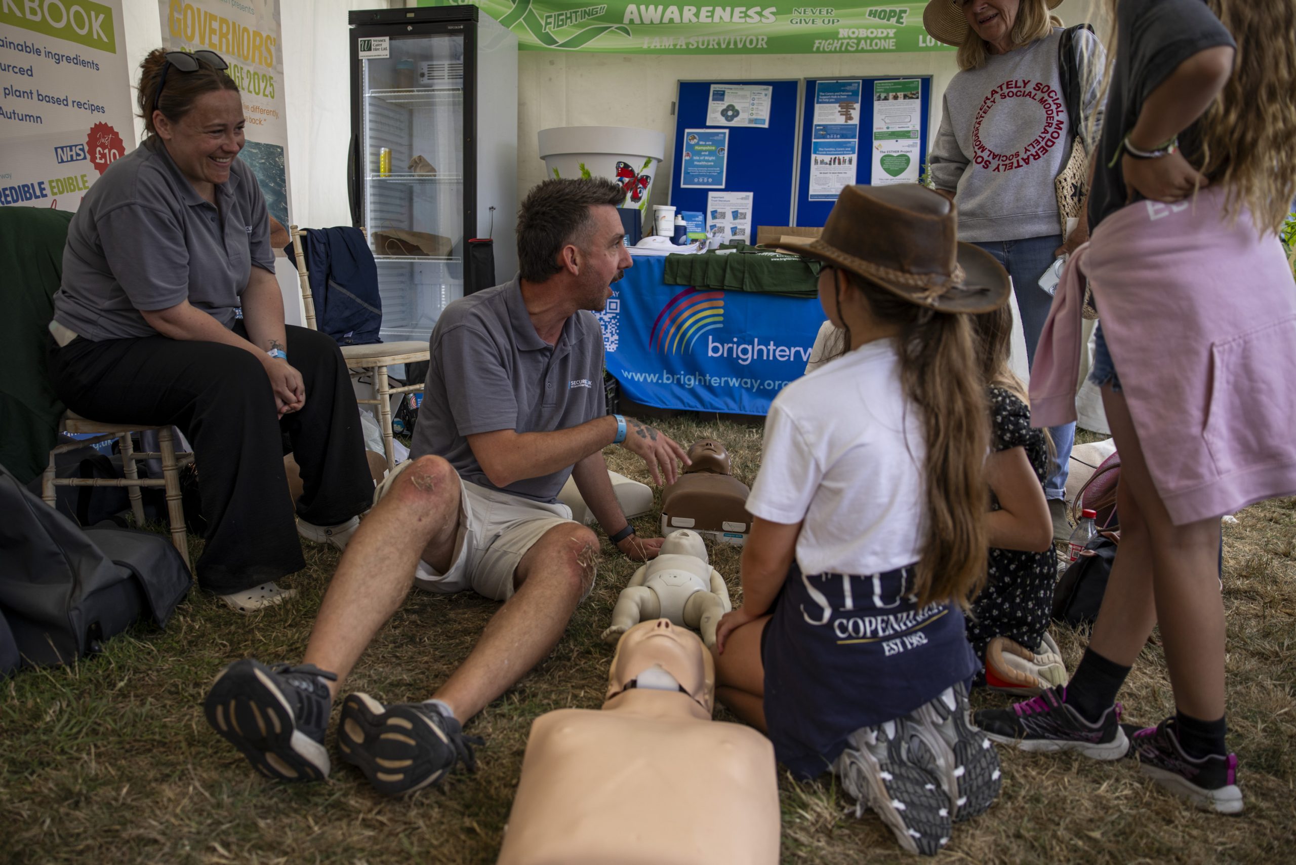 A professional displays CPR techniques to adults and children at the New Forest Show 2025